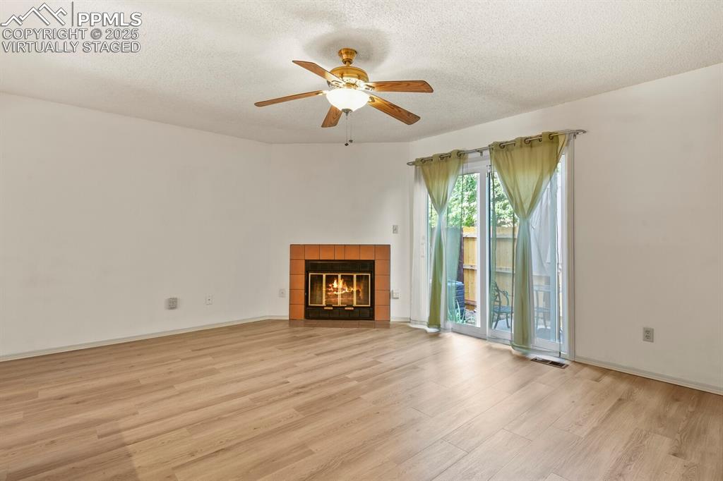 Image 3 of 30: Unfurnished living room featuring light wood-style flooring, a ceiling fan,