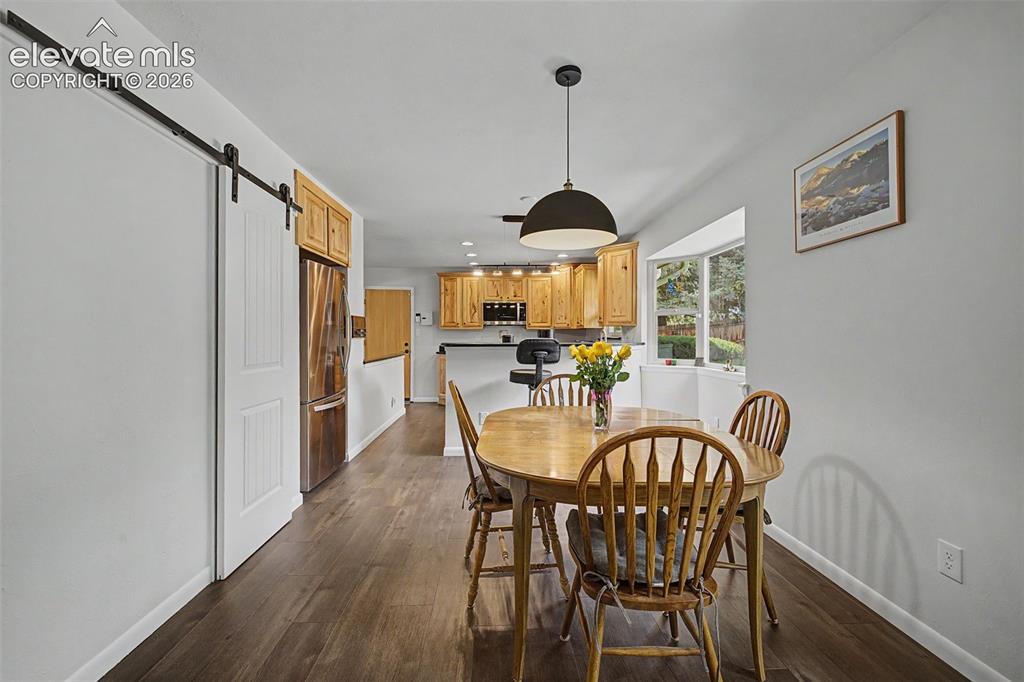 Image 12 of 43: Breakfast area in the kitchen featuring a bay window overlooking the gorgeo