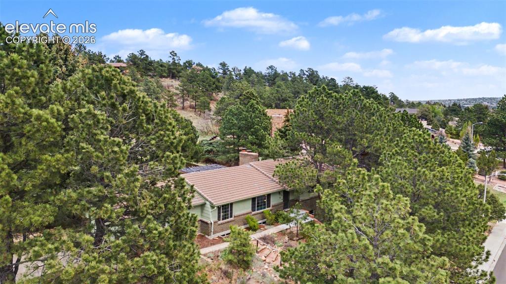 Image 3 of 43: The treed lot provides shade and privacy