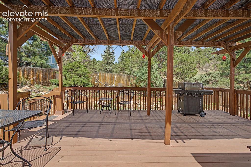 Image 31 of 43: Spacious deck with a pergola- perfect for relaxing or entertaining