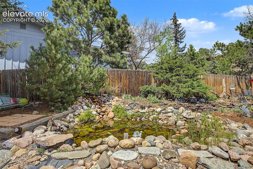Image 34 of 43: Beautiful koi pond with fountain