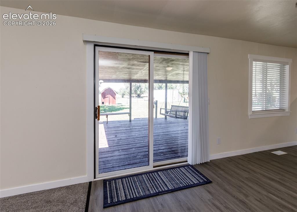 Image 12 of 49: Sliding glass door from Dining Room to covered deck
