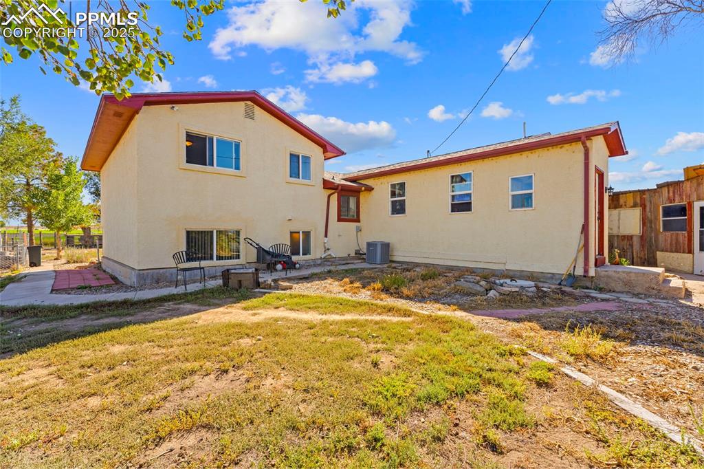 Image 17 of 22: Back of property featuring a patio and stucco siding