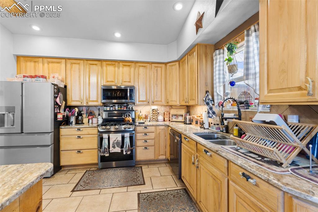 Image 7 of 22: Spacious country kitchen with plenty of cabinetry, and special detailed tou