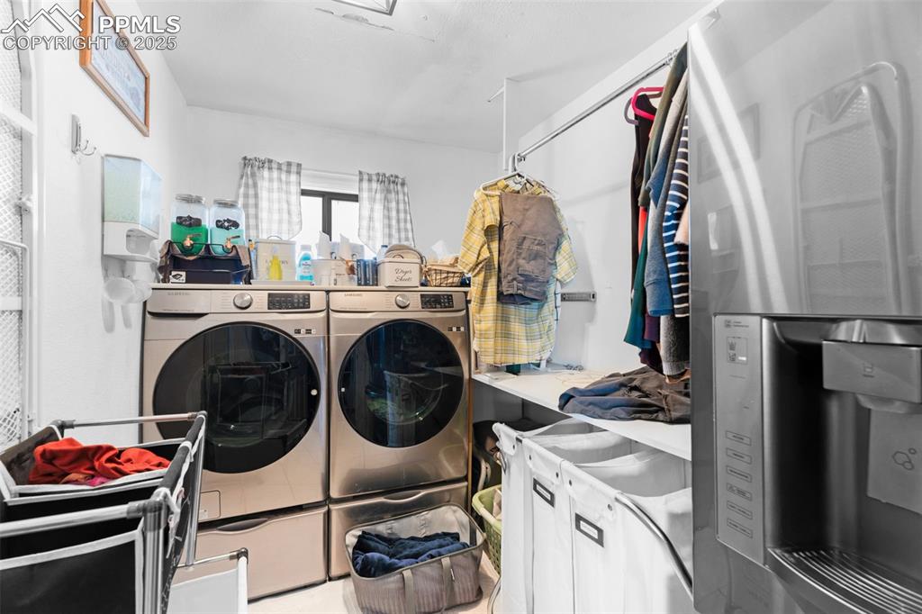 Image 9 of 22: Laundry area with separate washer and dryer