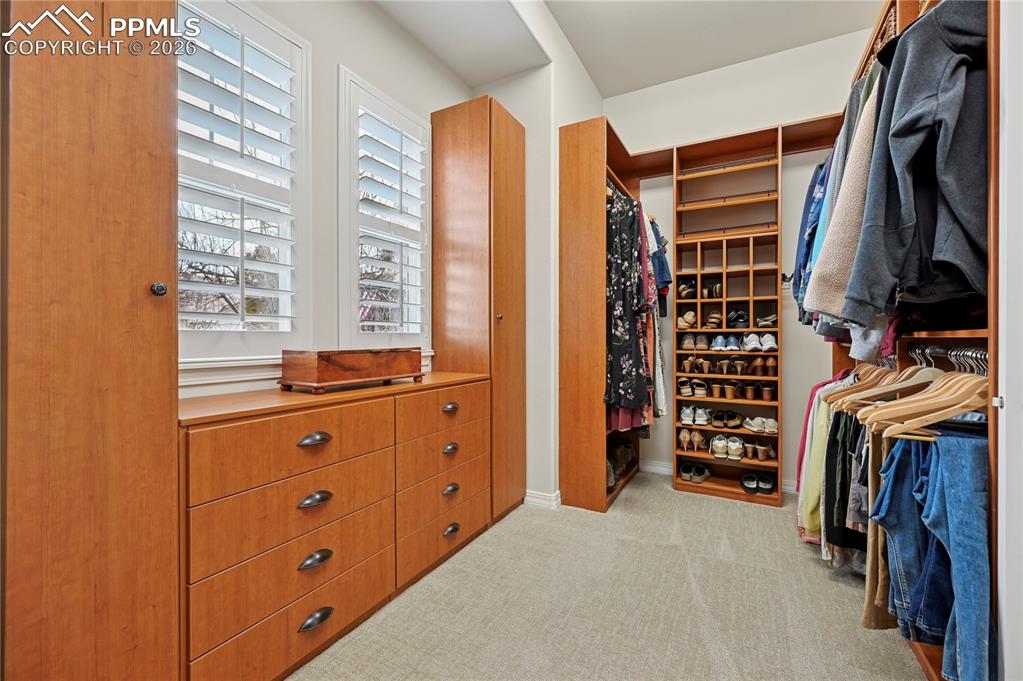 Image 24 of 50: Walk in closet with light colored carpet