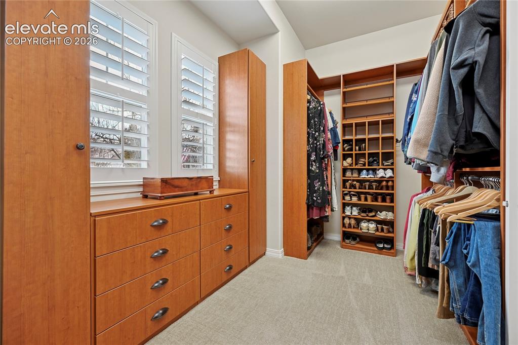 Image 24 of 49: Walk in closet with light colored carpet