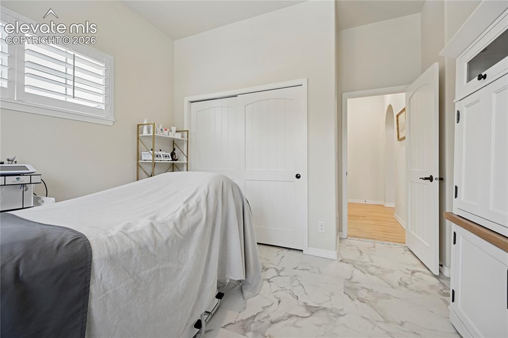 Image 26 of 49: Bedroom with light marble finish flooring and a closet