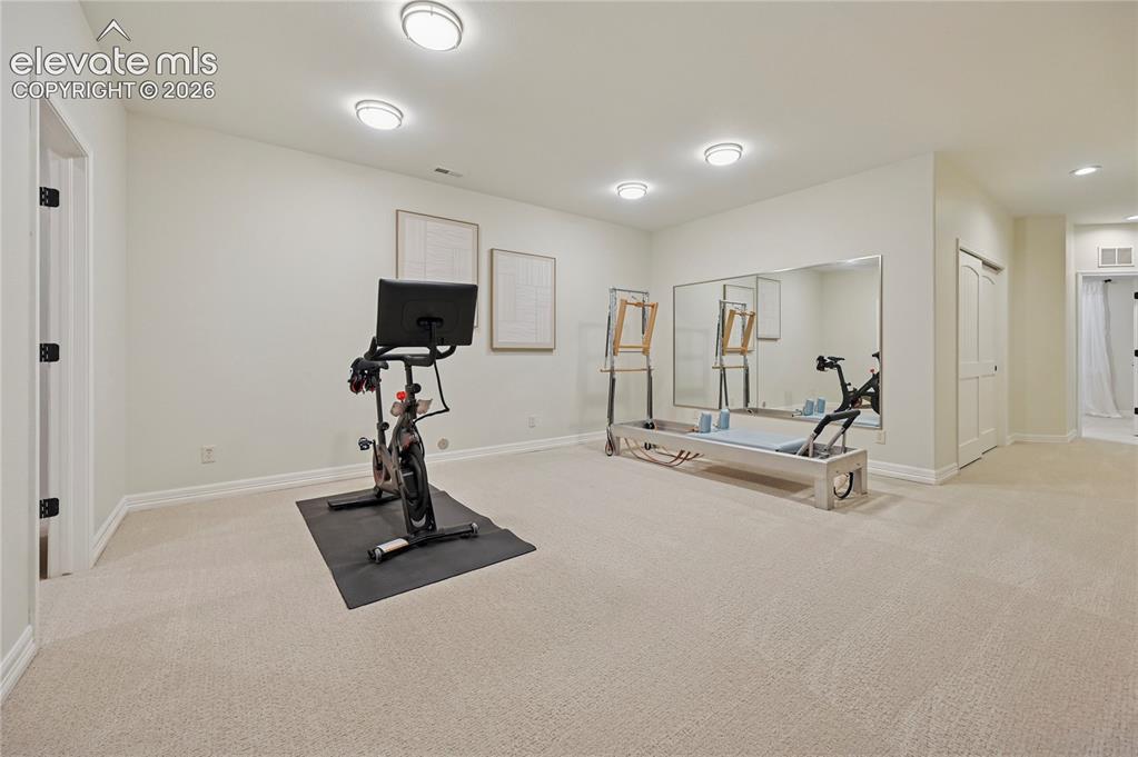 Image 28 of 49: Workout room featuring light colored carpet