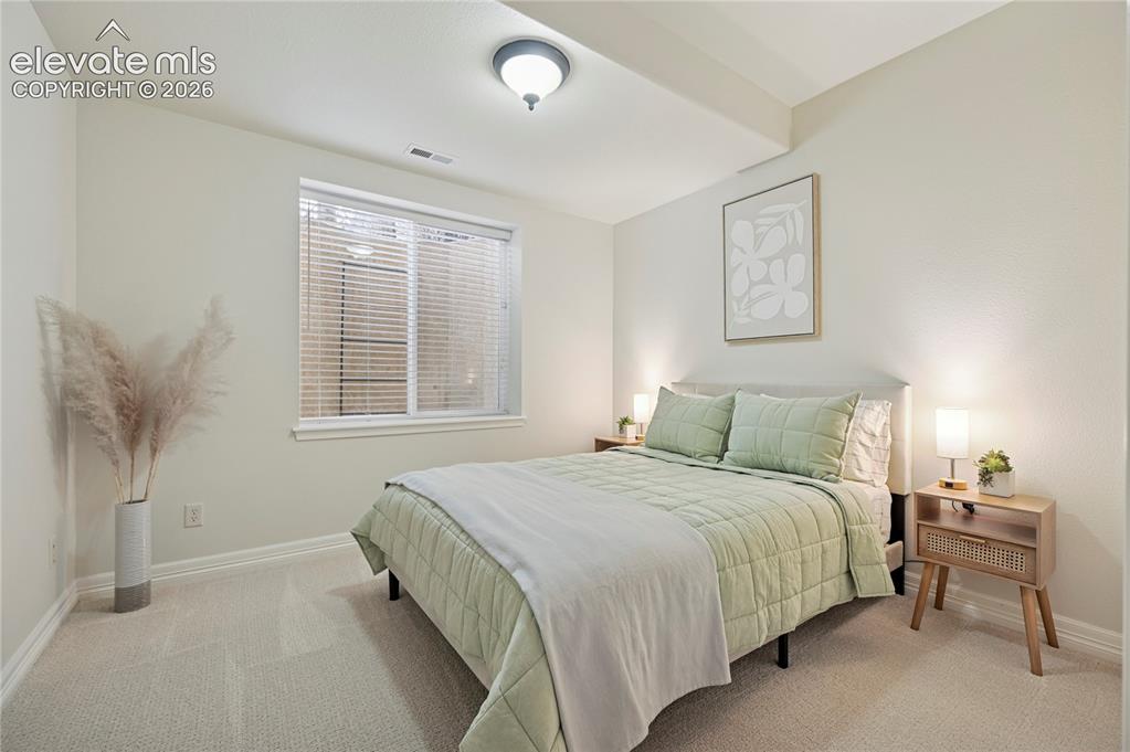Image 34 of 49: Bedroom featuring light carpet and baseboards