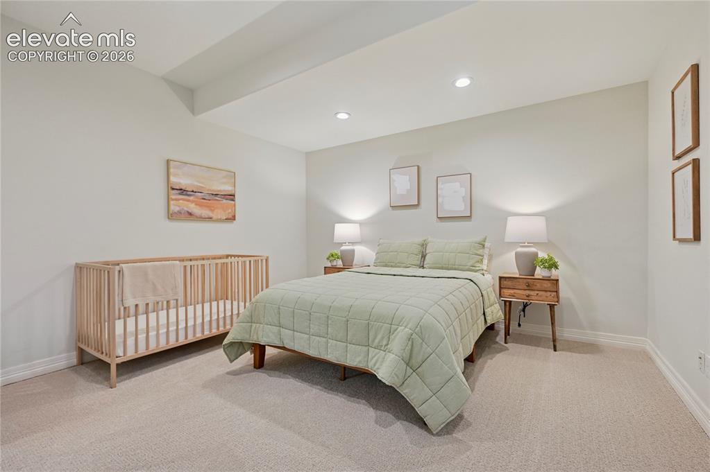 Image 37 of 49: Bedroom featuring light colored carpet and recessed lighting