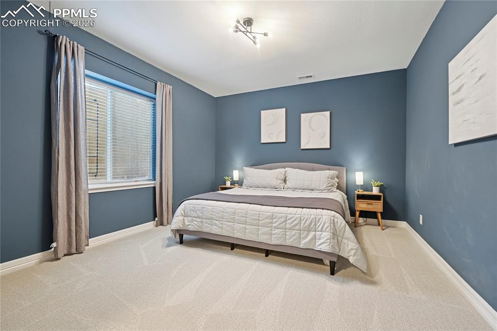 Image 39 of 49: Bedroom featuring baseboards and carpet floors