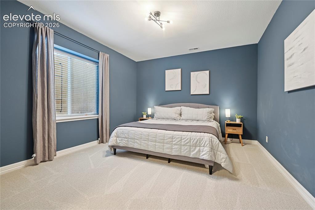 Image 39 of 49: Bedroom featuring baseboards and carpet floors