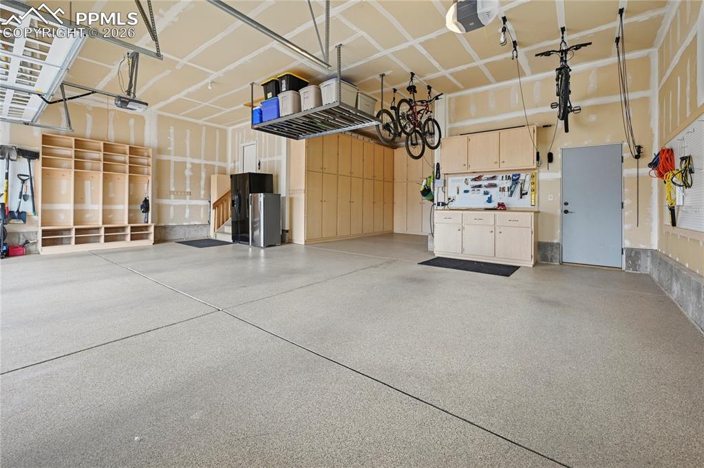 Image 43 of 50: Garage featuring a garage door opener