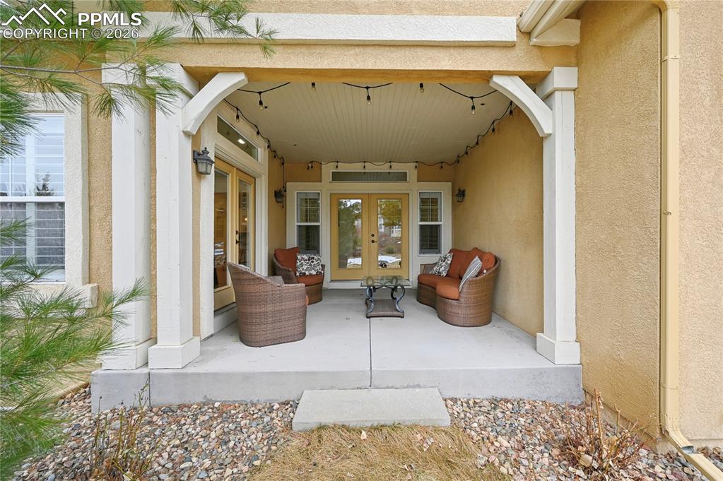 Image 46 of 50: View of patio with french doors