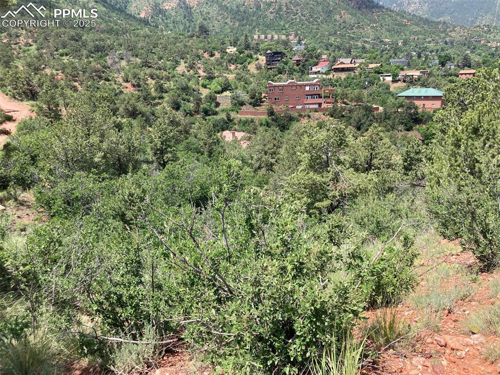 Image 12 of 12: View of property location featuring a heavily wooded area