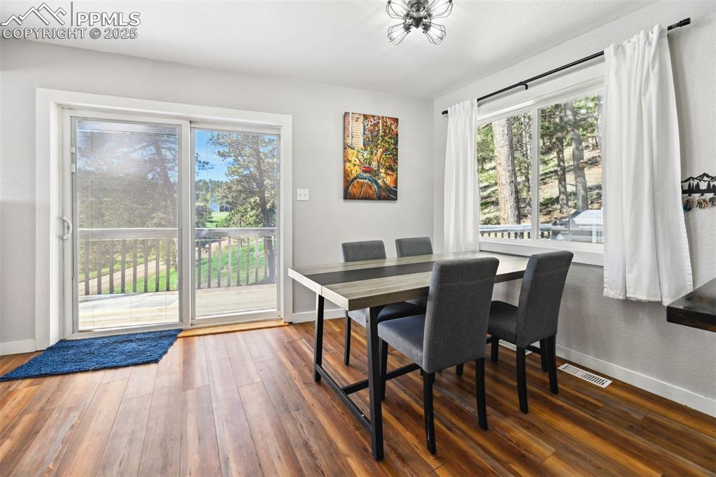 Image 11 of 49: Dining area with wood finished floors