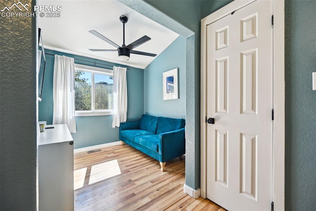 Image 15 of 49: Unfurnished room featuring a textured wall, a ceiling fan, light wood-type 