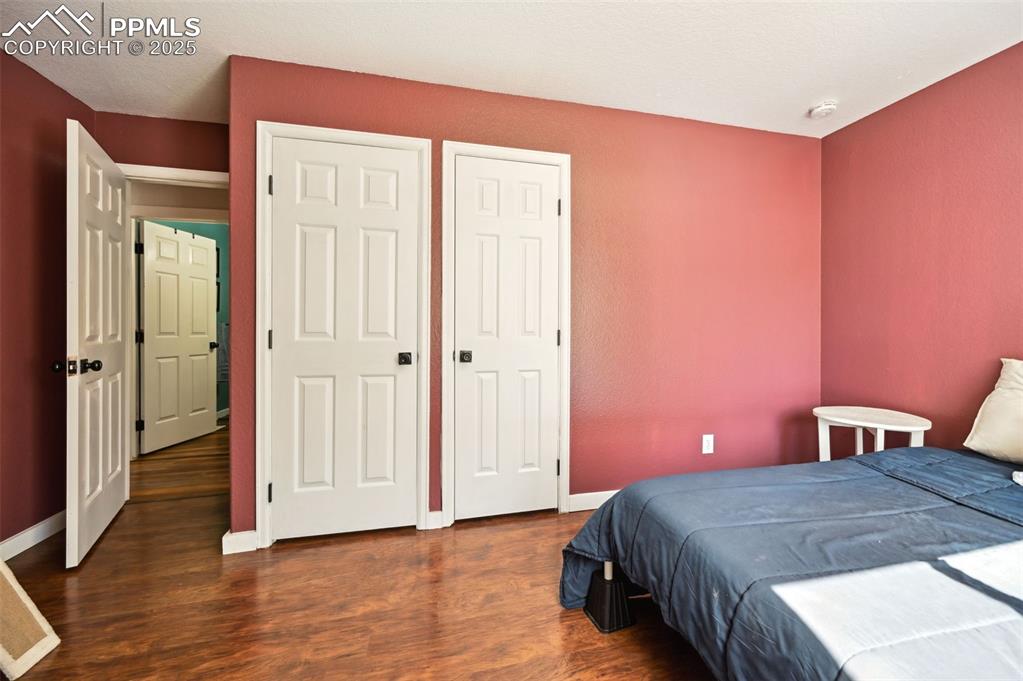 Image 27 of 49: Bedroom featuring wood finished floors and baseboards
