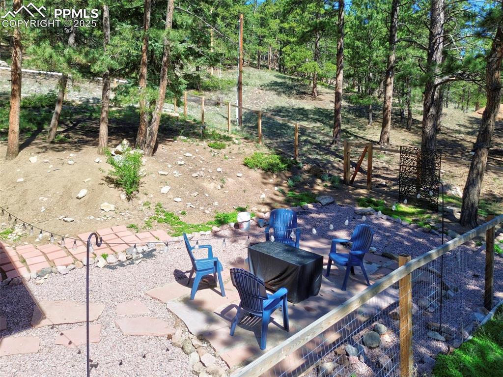 Image 39 of 49: View of patio with an outdoor fire pit