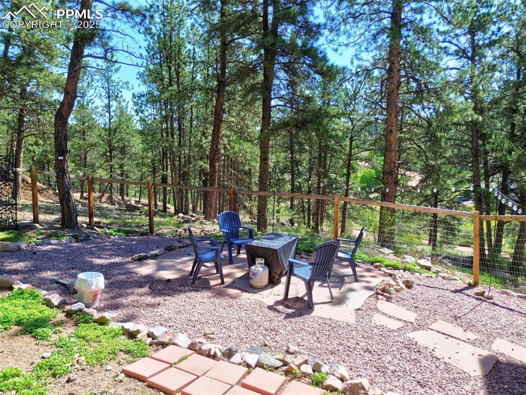 Image 40 of 49: View of patio / terrace featuring an outdoor fire pit