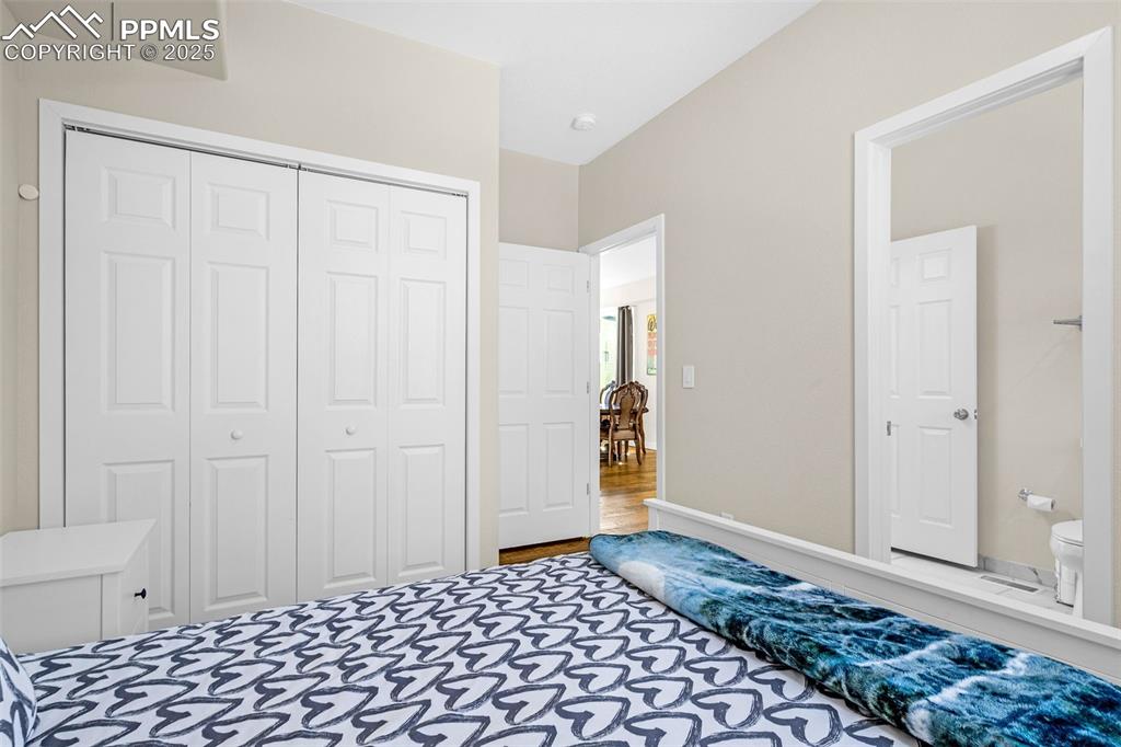 Image 11 of 37: Main Level Bedroom with engineered hardwood floor, closet and main level ba