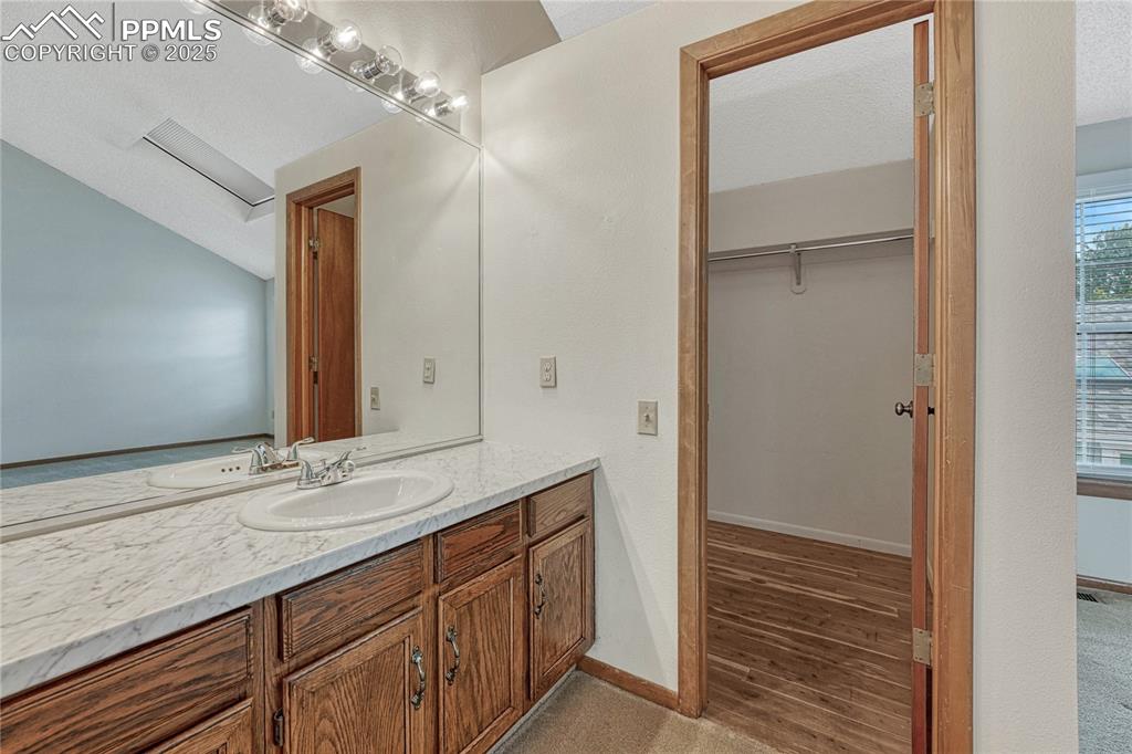 Image 17 of 28: Primary bedroom with dedicated vanity space and...