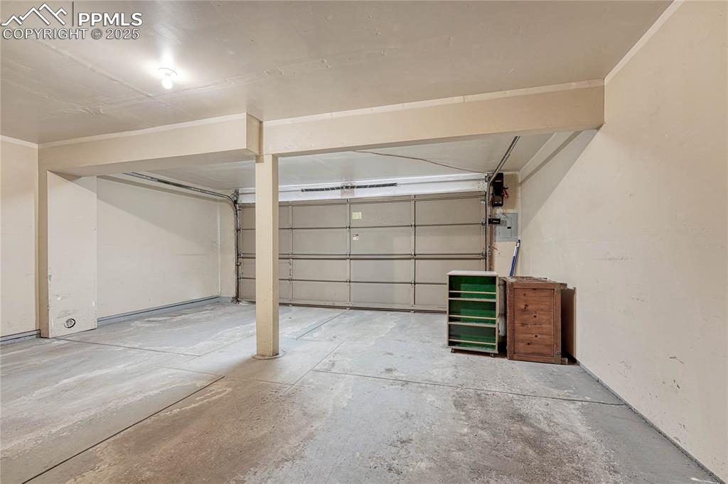 Image 24 of 28: 2-car garage with water spigot.