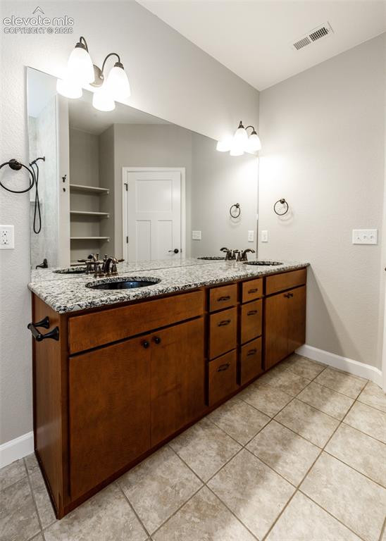 Image 18 of 27: Primary bath with double granite vanity.