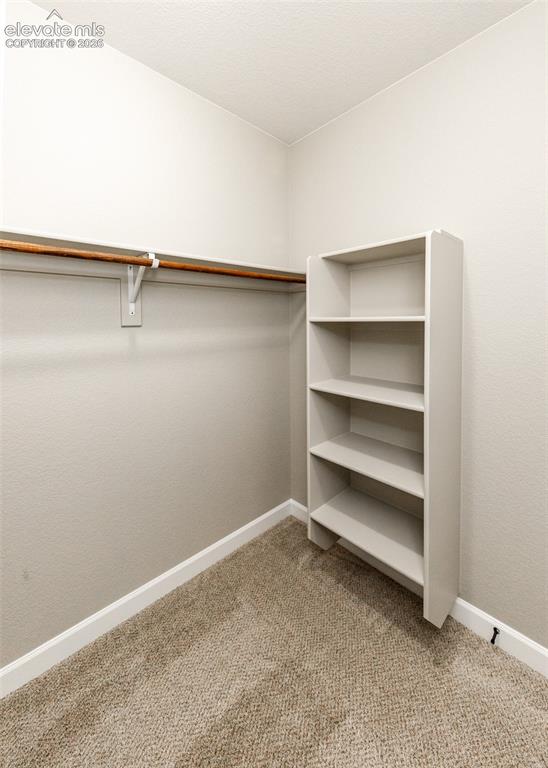 Image 20 of 27: Walk in closet off the primary bedroom.