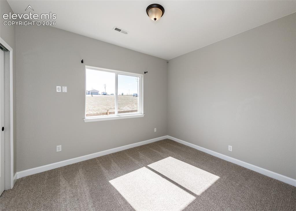 Image 21 of 27: First secondary bedroom.