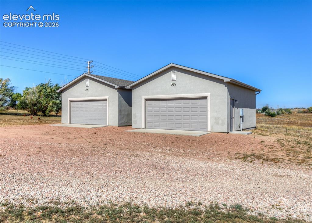Image 3 of 27: Lots of parking space with two oversized, detached two car garages. One wit