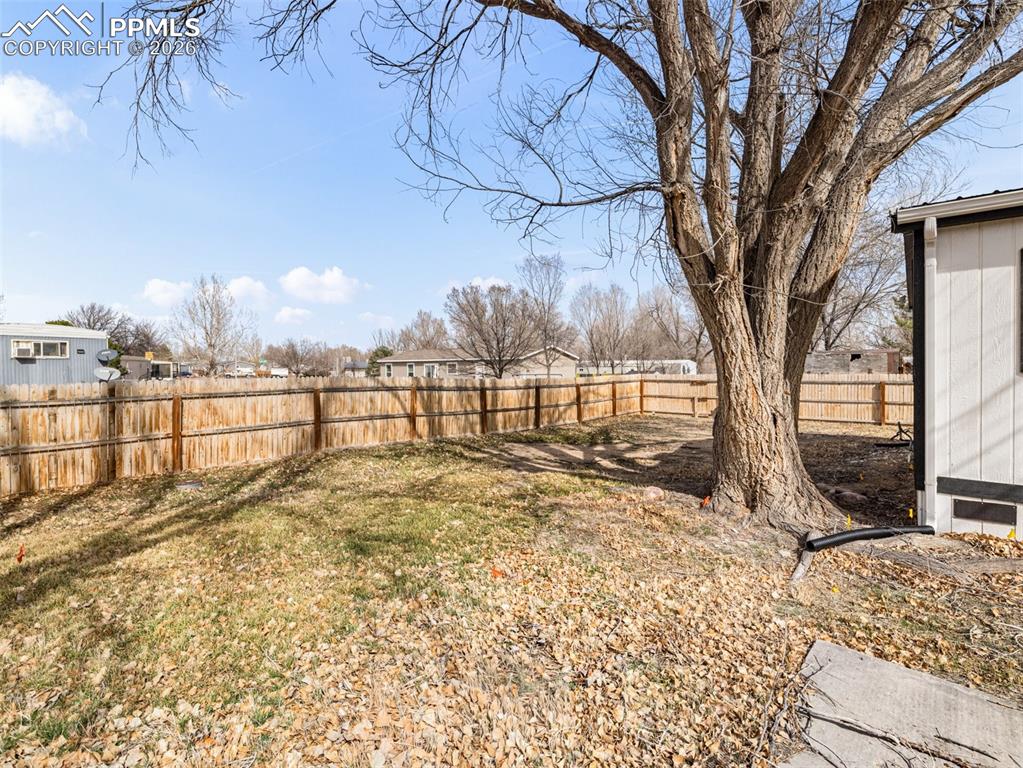 Image 4 of 29: View of fenced backyard