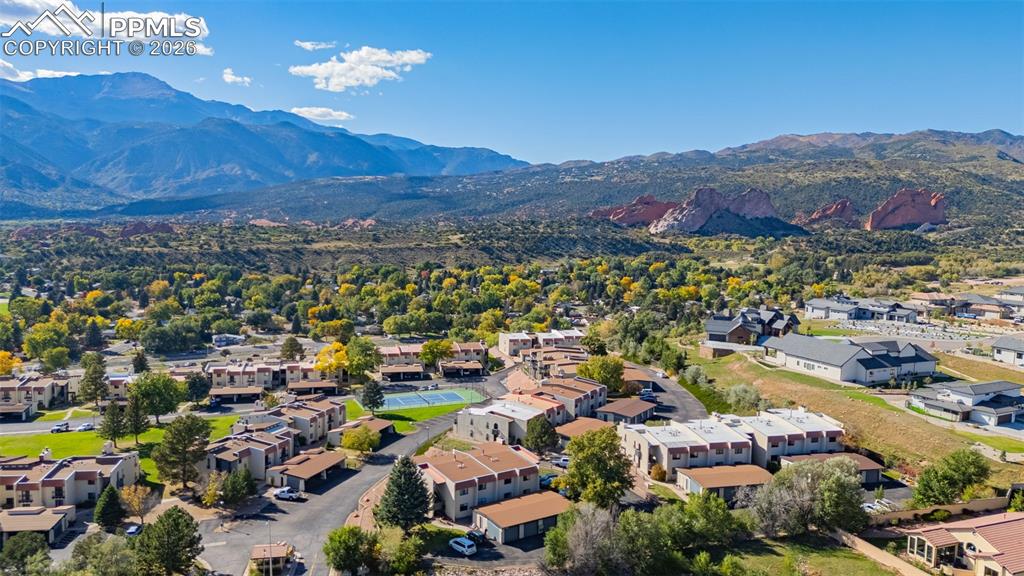 Image 19 of 29: Aerial view of residential area featuring a mountain backdrop