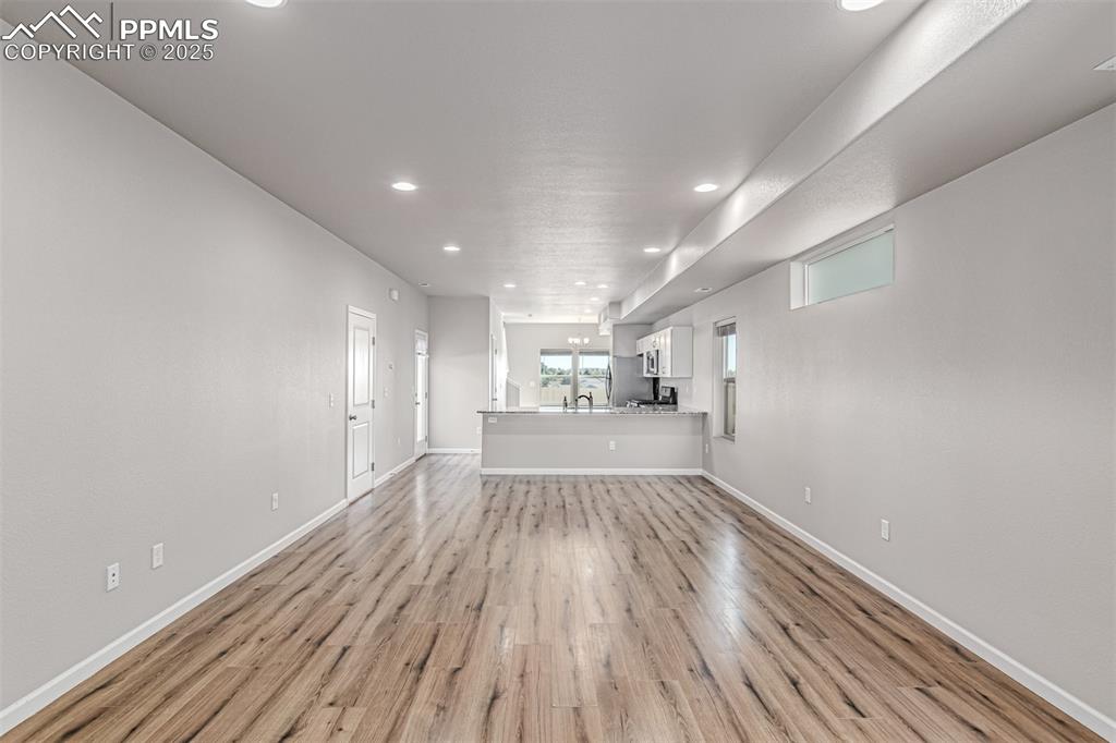 Image 3 of 29: Unfurnished living room featuring light wood-type flooring and recessed lig