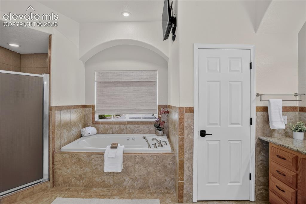 Image 13 of 37: 5-piece primary bath w/ jetted tub & large linen closet