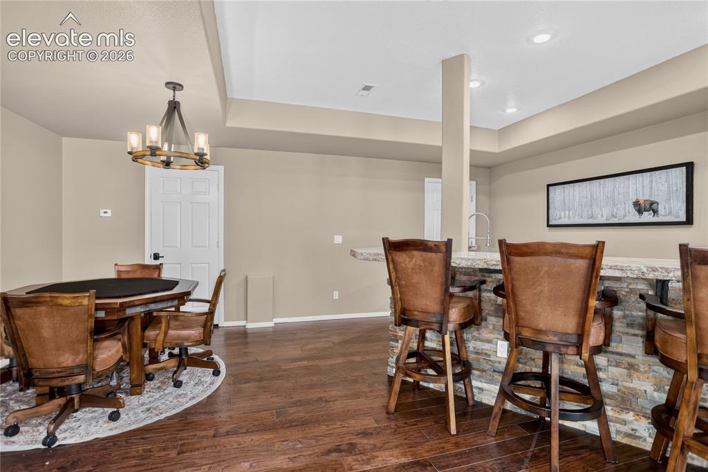 Image 23 of 37: Wet bar w/ barstool seating & matching game table set