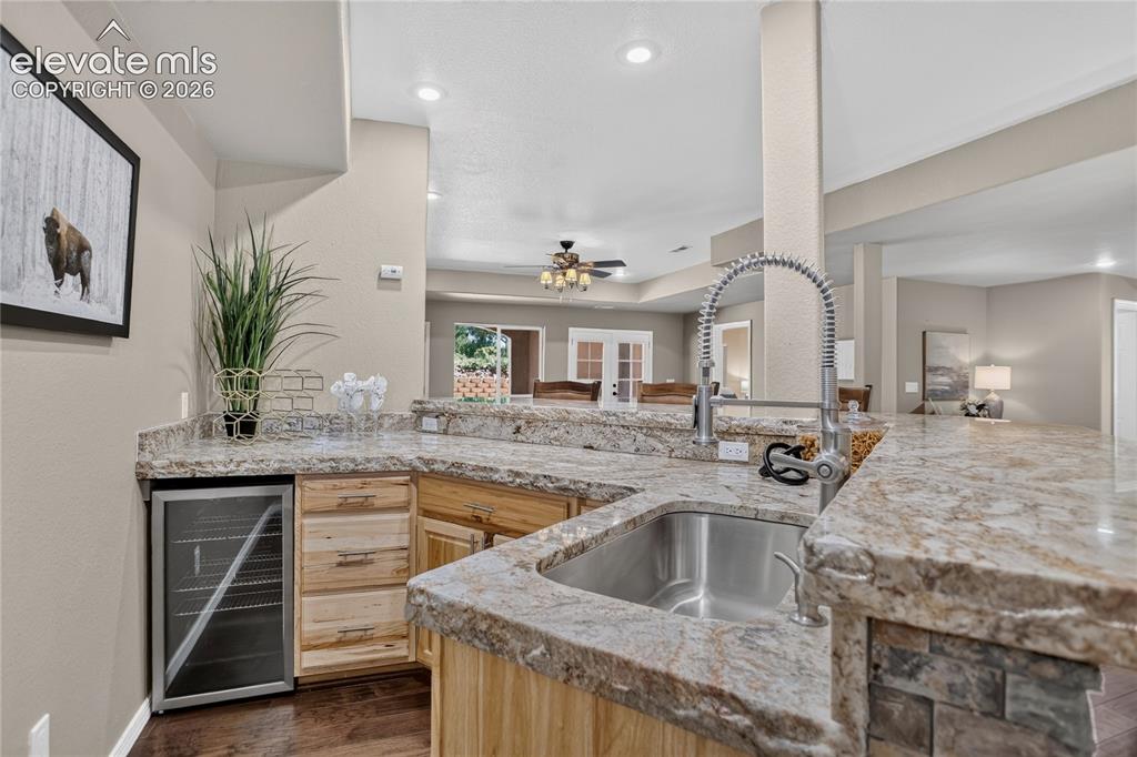 Image 24 of 37: Wet bar comes with chiseled-edge granite counter & beverage fridge