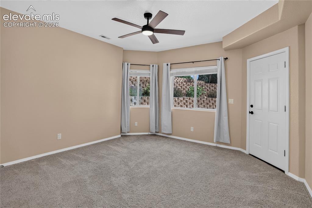 Image 28 of 37: Bedroom 4 w/ walk-out to patio - lower level