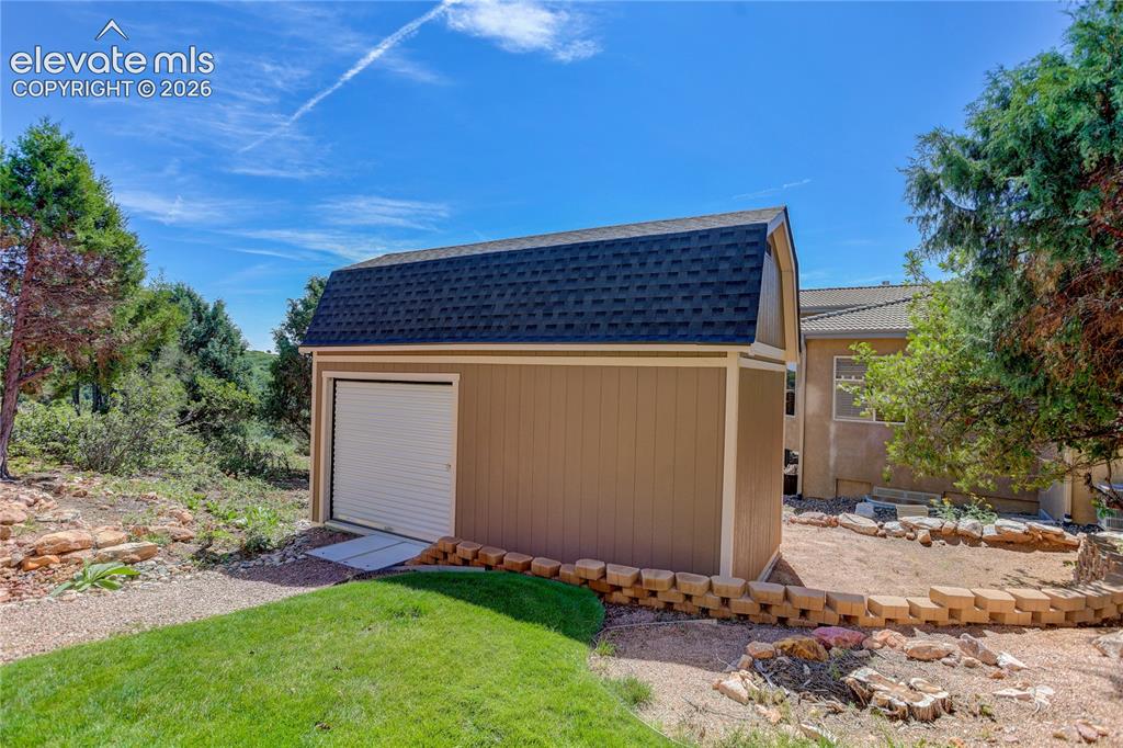 Image 34 of 37: Enormous storage shed (20x10) w/ roll-up door, loft, & workbench