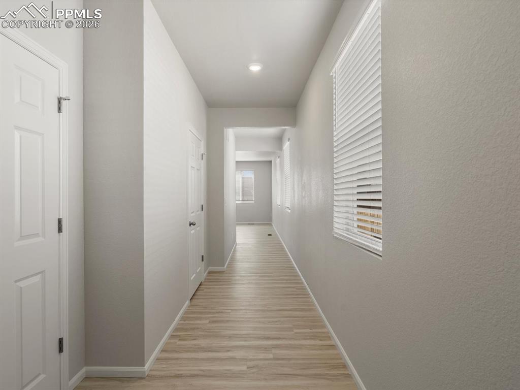 Image 2 of 30: Hallway featuring baseboards and light wood-style floors