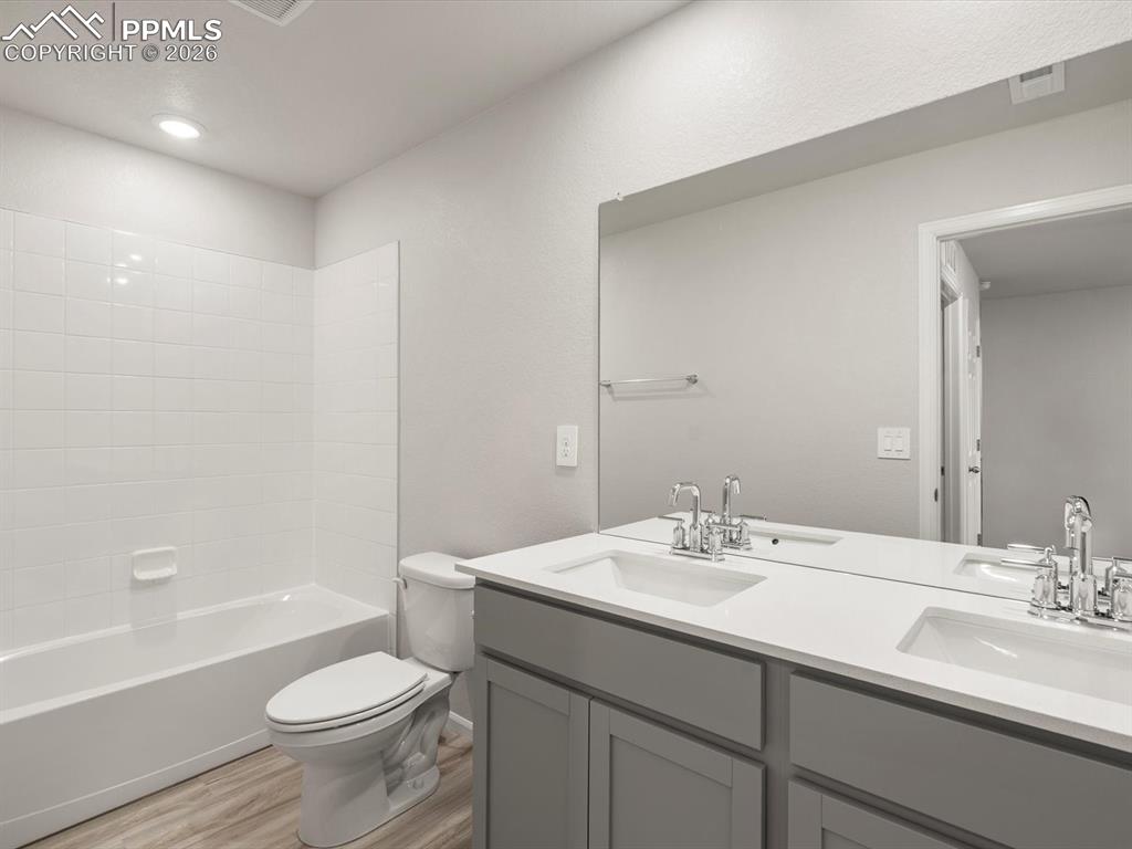 Image 22 of 30: Full bathroom featuring bathing tub / shower combination, double vanity, an