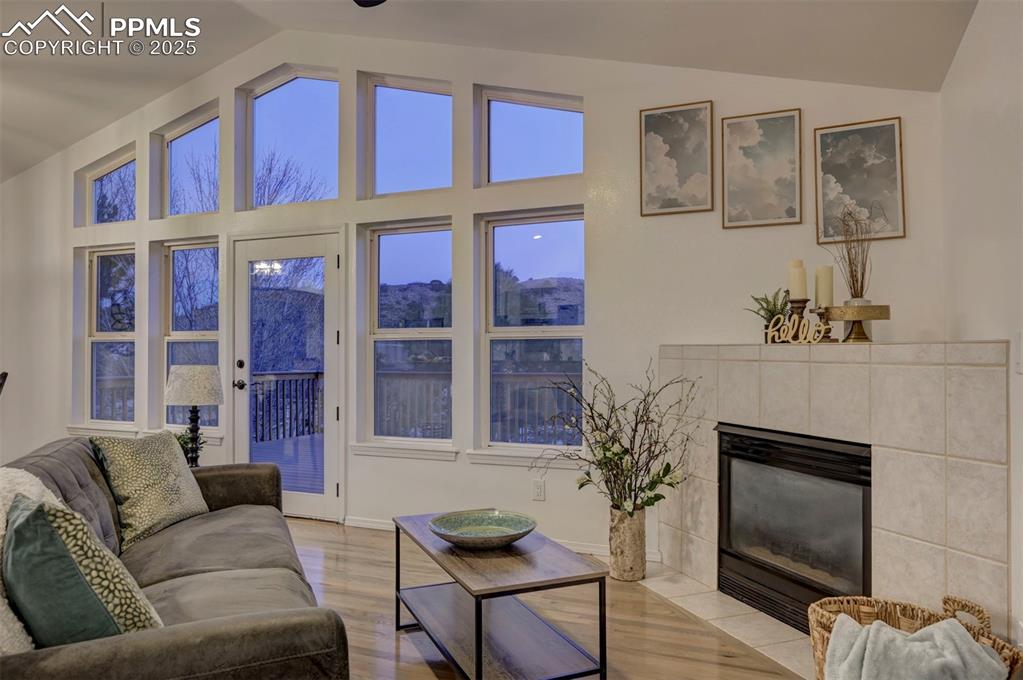 Image 12 of 50: The Great Room has a vaulted ceiling, hardwood floors, a gas fireplace with