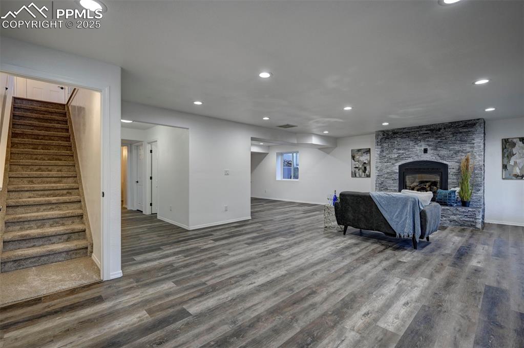 Image 34 of 50: Finished Garden Level Basement with new LVP flooring and gas fireplace with