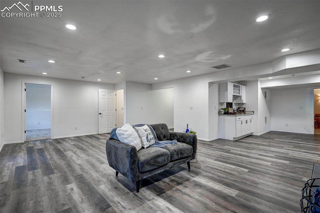 Image 37 of 50: Family Room and wet bar. Room for mini frig or drink cooler.