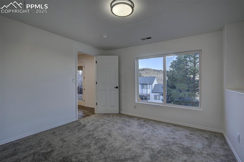 Image 42 of 50: Basement Bedroom #4 with large window that brings in lots of natural light.