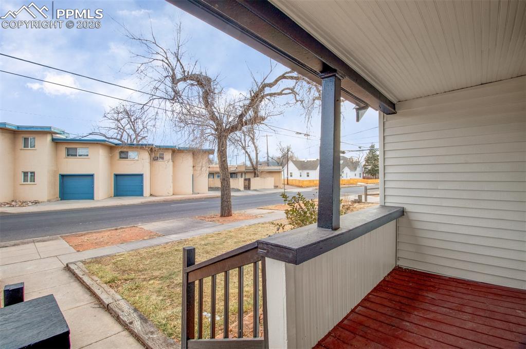 Image 15 of 24: Covered front porch with room for outdoor seating