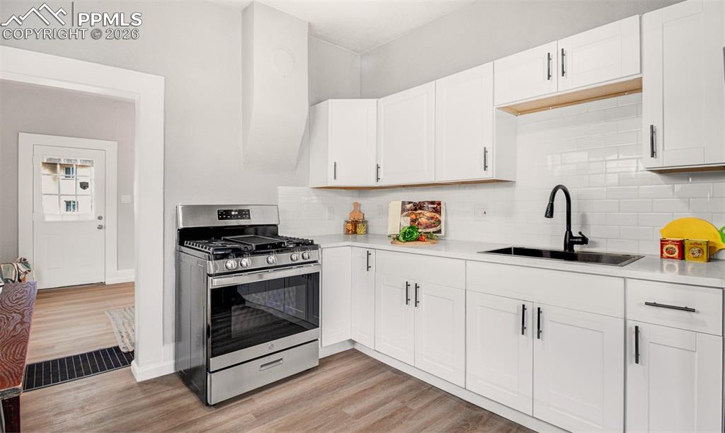 Image 6 of 24: Quartz countertops and a gas range