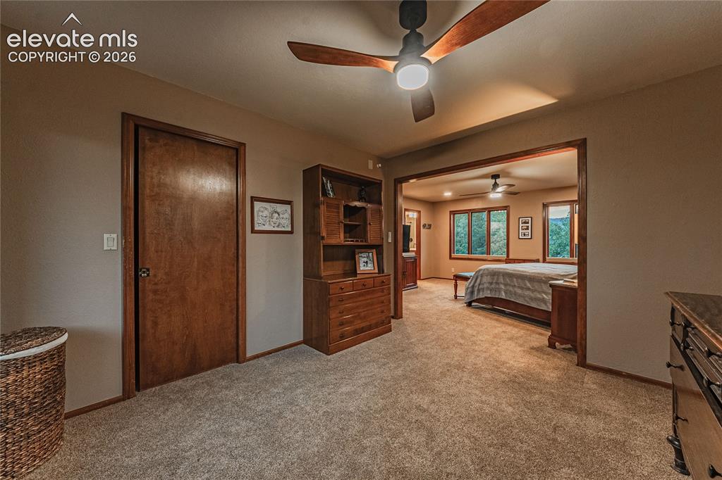 Image 21 of 43: Bedroom featuring ceiling fan and light colored carpet