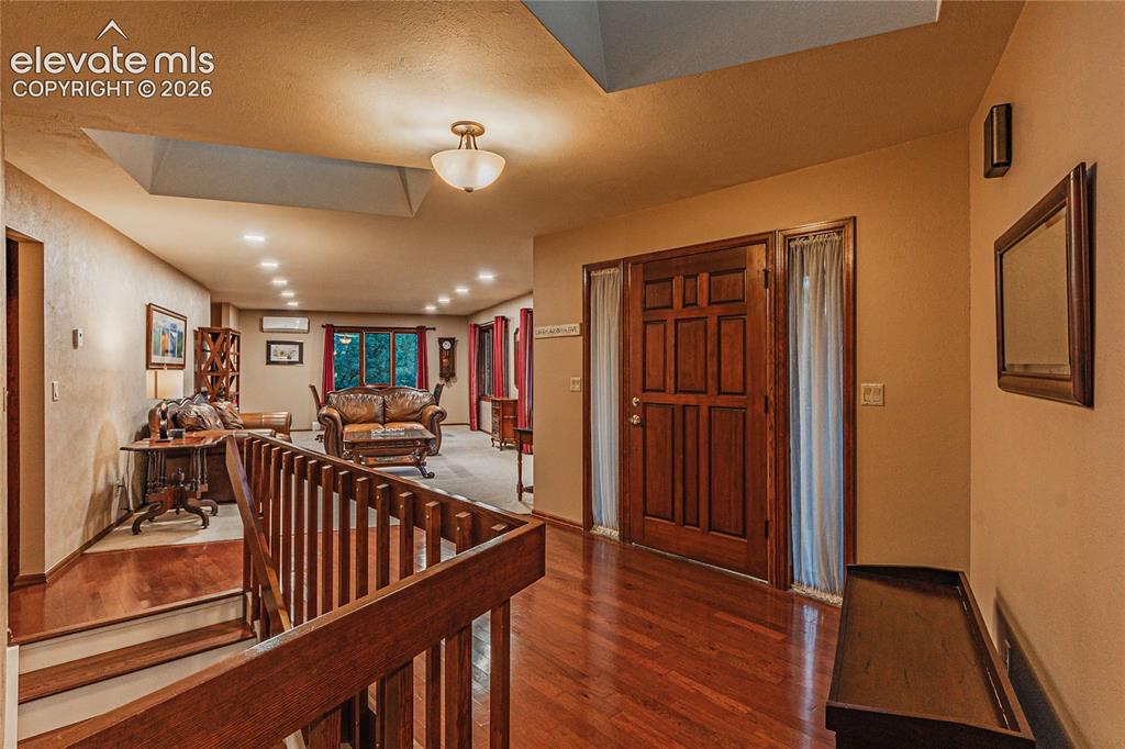 Image 30 of 50: Foyer entrance featuring a textured ceiling and dark wood-type flooring